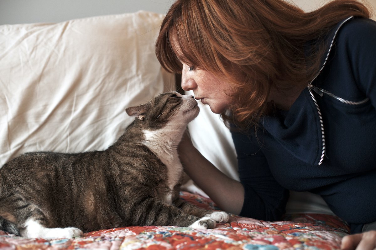 Woman kissing cat