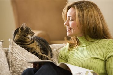 woman looking at cat